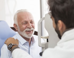 Senior Patient consulting With Optician In Office