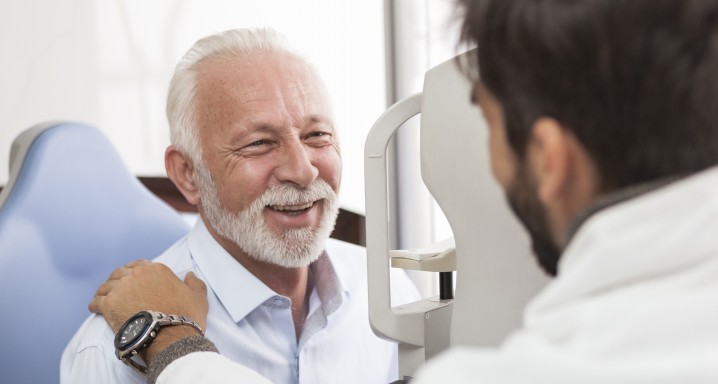 Senior Patient consulting With Optician In Office