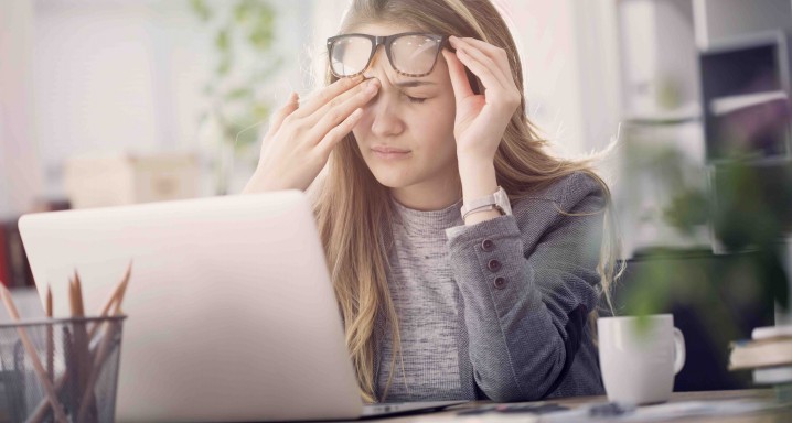 Young tired working woman at work